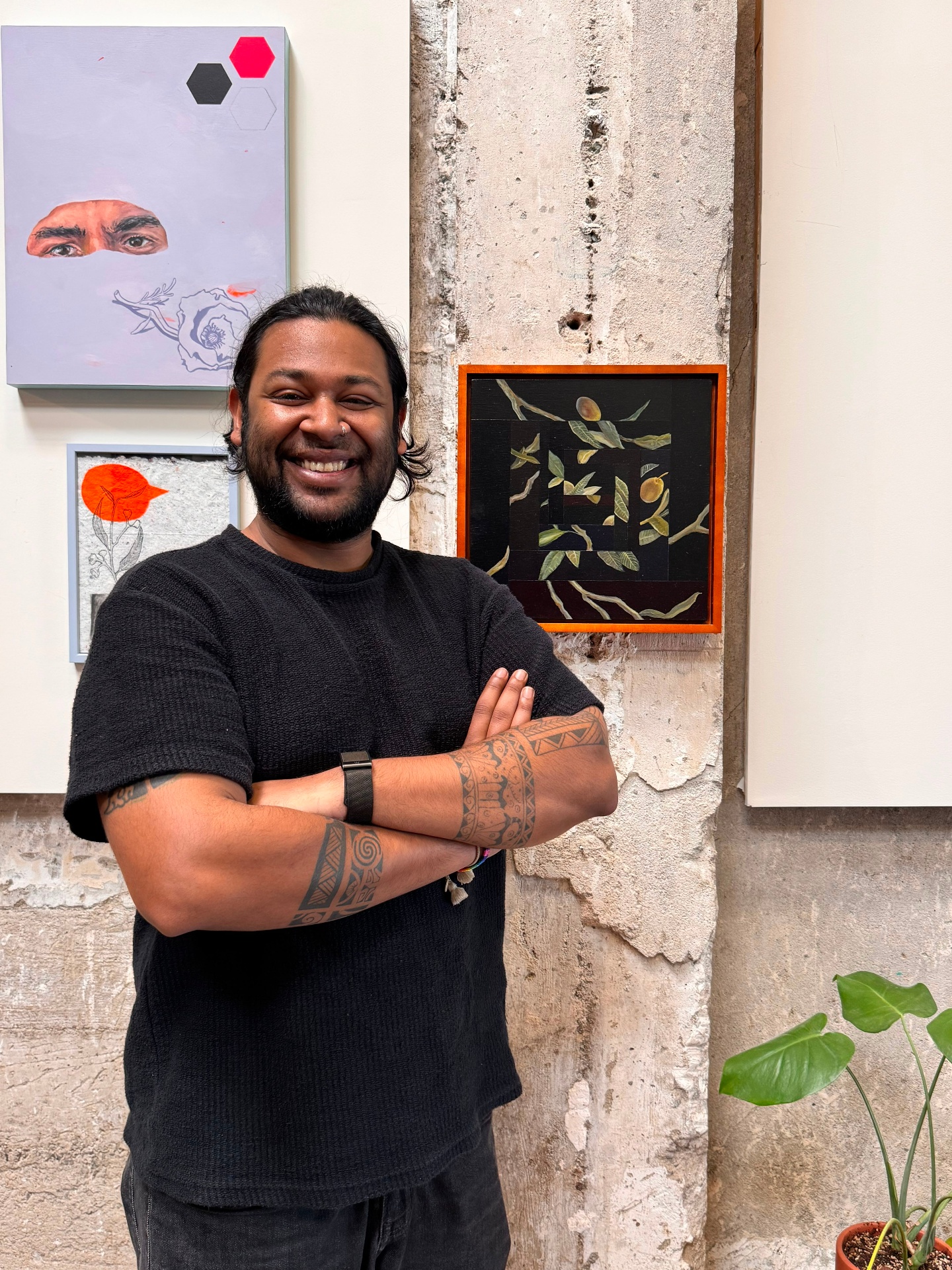 The Growth Gremlin standing in front of an art wall, arms crossed